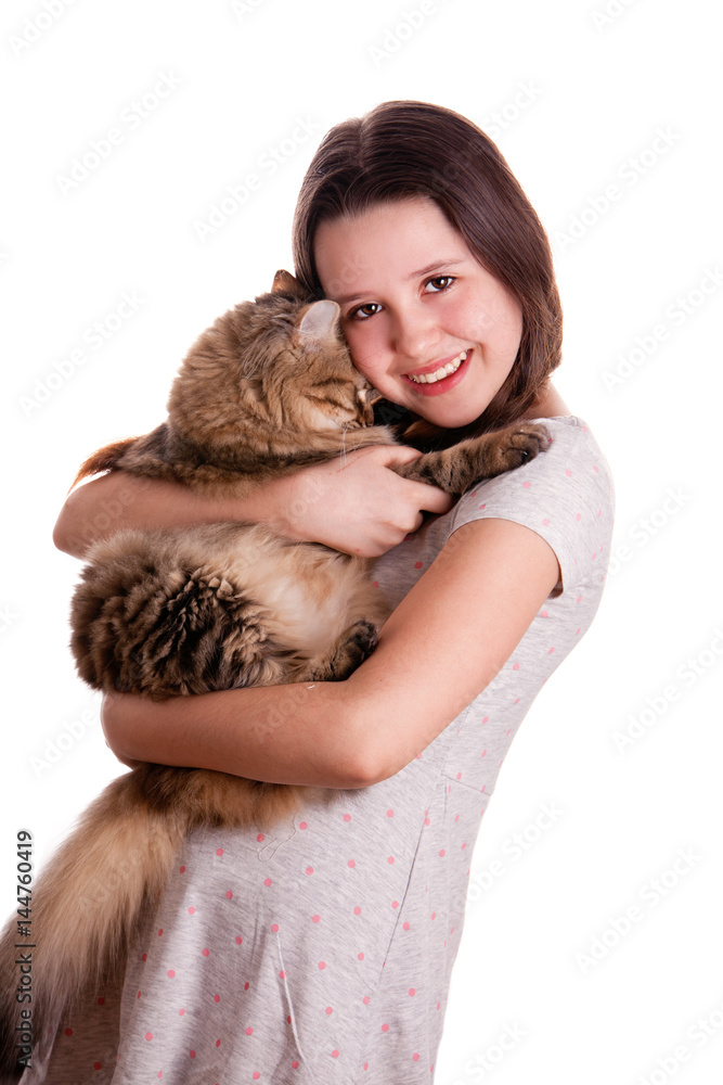 Portrait of the happy teenage girl with the cute fluffy cat over the white background Portrait of the happy teenage girl with the cute fluffy cat over the white background