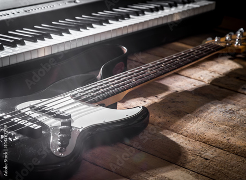 piano and guitar on wooden background closeup