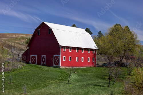 Bright red barn on a sunny day.