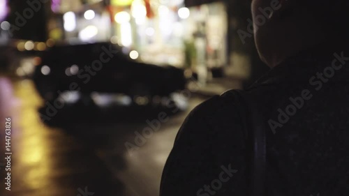 woman walking alone in urban night