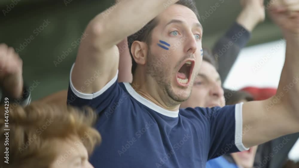 Excited sports crowd with national flags cheering on their teams Excited sports crowd with national flags cheering on their teams