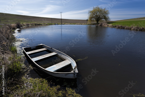 Old row boat in a small pond.