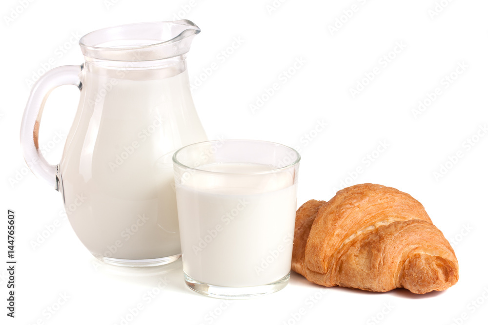 Jug and glass of milk with croissant isolated on white background Jug and glass of milk with croissant isolated on white background
