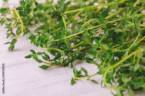 Bunch of fresh organic thyme on wooden background