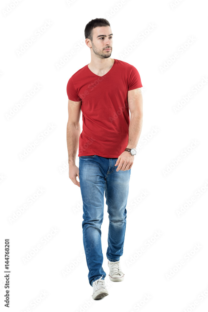 Young handsome casual man walk towards camera looking away. Full body length portrait isolated over white studio background. Young handsome casual man walk towards camera looking away. Full body length portrait isolated over white studio background.