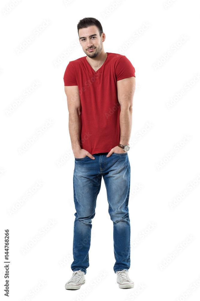 Smiling handsome casual man with hands in pockets looking at camera. Full body length portrait isolated over white studio background. Smiling handsome casual man with hands in pockets looking at camera. Full body length portrait isolated over white studio background.