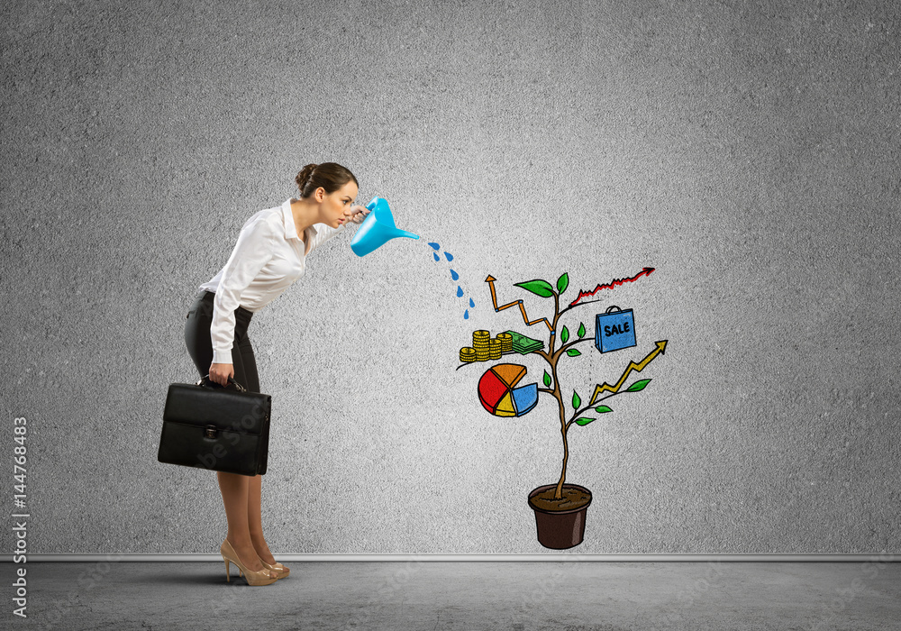 Young businesswoman in empty room watering drawn growth concept with can Young businesswoman in empty room watering drawn growth concept with can