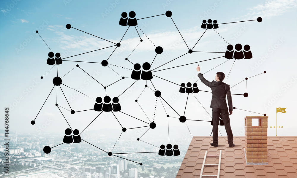 Businessman on house roof presenting networking and connection concept. Mixed media Businessman on house roof presenting networking and connection concept. Mixed media