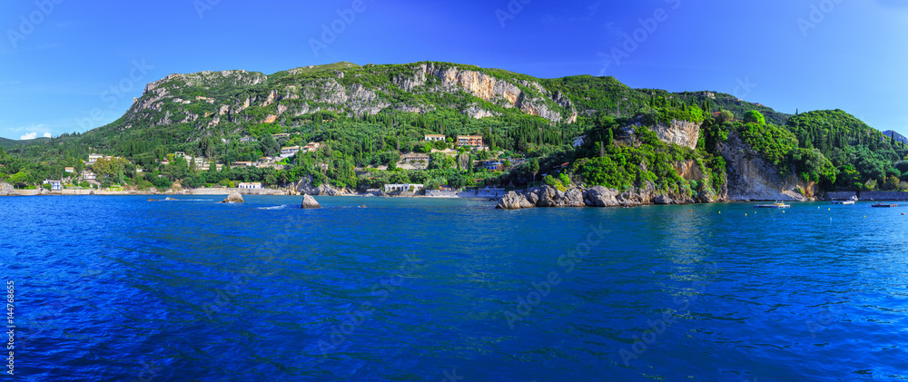 Beautiful summer panoramic seascape. View of the coastline into the sea bays with crystal clear azure water. Paleokastrica. Corfu. Ionian archipelago. Greece.