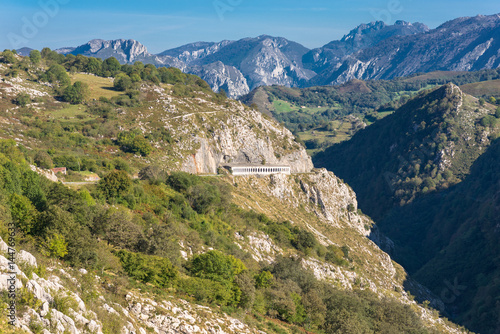 Crossing woodland and mountain pasture, to discover the nature of  the foothills of the National Park Los Picos de Europa. In the background, peaks of the famous limestone mountain range © ksl