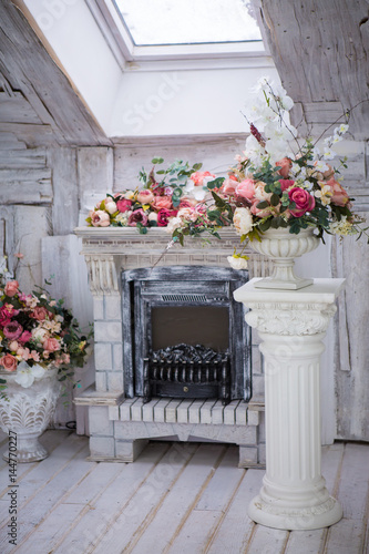 Fototapeta Naklejka Na Ścianę i Meble -  Fireplace and decor of flowers