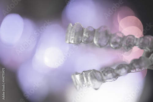 Invisible dental orthodontics on colored background