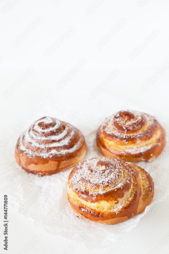 Sweet rolls with sugar and cinnamon on white background. Sweet rolls with sugar and cinnamon on white background.