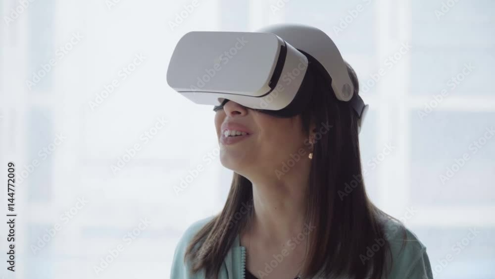Close up woman's face in vs headset against the window Close up woman's face in vs headset against the window
