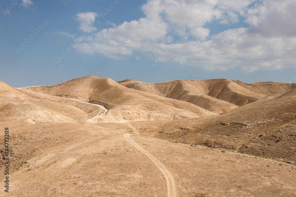 Dry Judean desert with a little sandy road