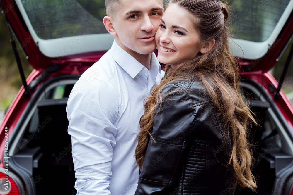 Beautiful guy with a girl smile, stand near the car, cool. Love story Beautiful guy with a girl smile, stand near the car, cool. Love story