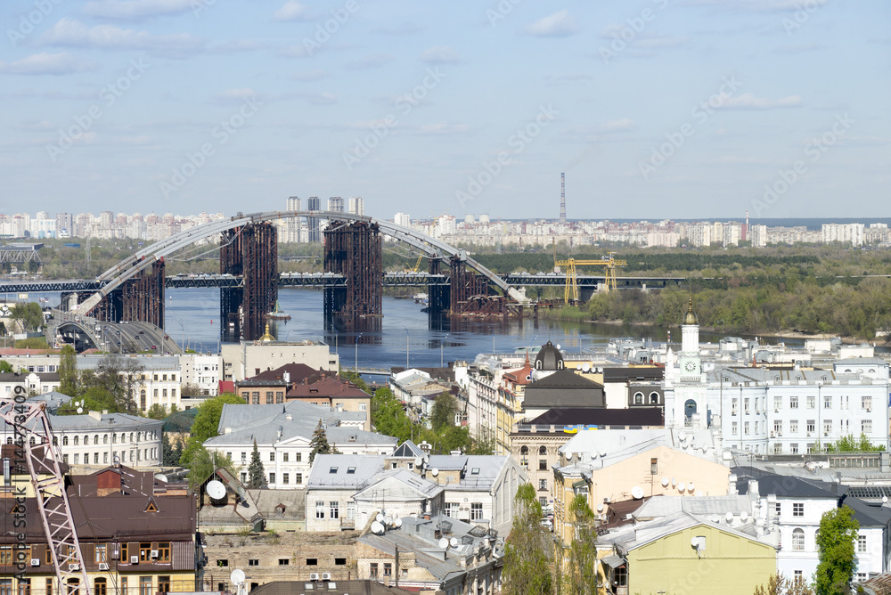View of Podil, the historic district of Kyiv, and the Podilsko-Voskresenskyi Bridge which is under construction.