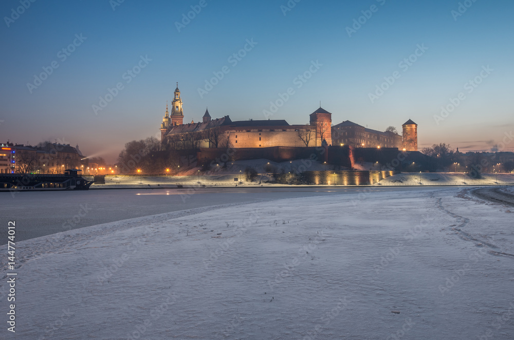 Krakow, Poland, Wawel Castle and Wawel cathedral in the winter over frozen Vistula river in the morning