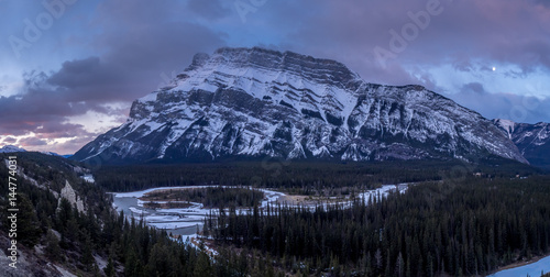 The Bow River meandering below the Rundle Mountain in Banff National Park at sunrise.