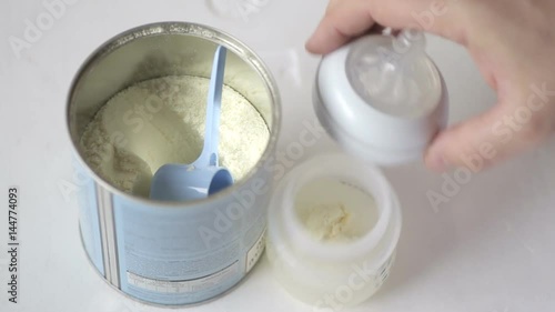 Man makes infant milk formula for a baby