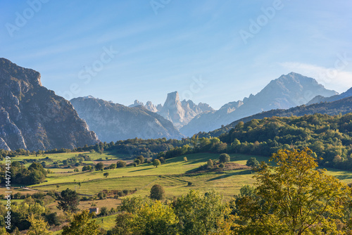 The foothills of the National Park Los Picos de Europa. In the background, peaks of the famous mountain Naranjo de Bulnes photo