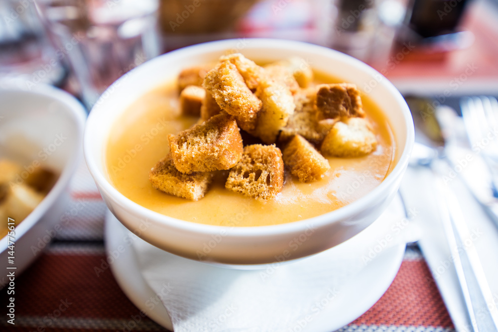 Sweet potato soup with creckers on table. Romanian dishes