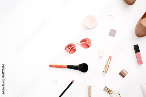 Beauty blog fashion concept. Female pink styled accessories: watches, sunglasses, cosmetics, shoes on white background. Flat lay, top view trendy feminine background.
