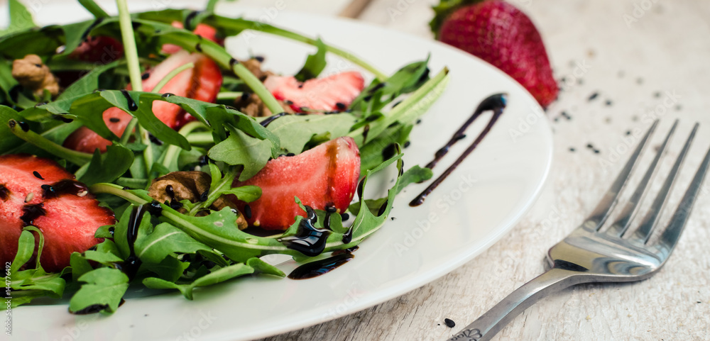Fresh salad with arugula and strawberries Fresh salad with arugula and strawberries