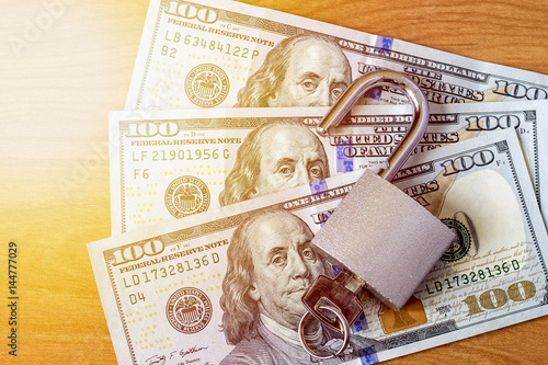 dollar currency notes with lock and chain. money stack for safety and investment.