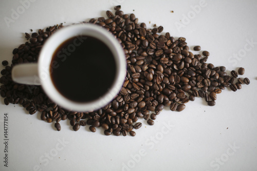 Fototapeta Naklejka Na Ścianę i Meble -  White Coffee Mug in Coffee Beans