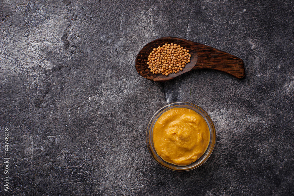 Fototapeta premium Mustard and seeds on concrete background