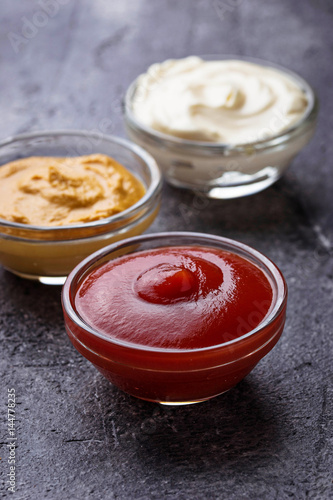 Set of different sauces: mustard, ketchup, mayonnaise.