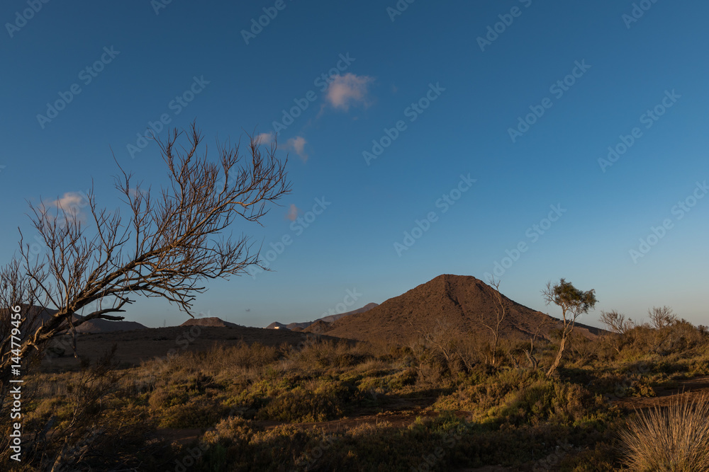 Fototapeta premium sunset over a dried plain an mountains