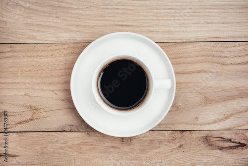 Coffee cup on rustic wooden table. 