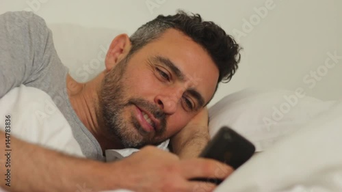 using smartphone in bed photo