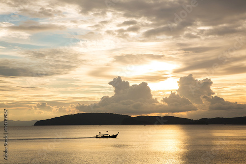 Blue golden sky in sunset with sea and boat