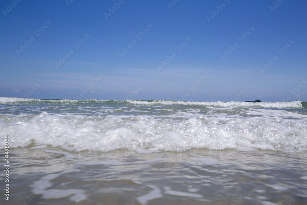 view of tropical beach with wave on the sunny sky. Summer paradise beach.