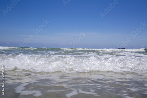 view of tropical beach with wave on the sunny sky. Summer paradise beach.