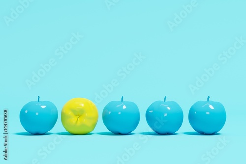 Outstanding yellow apple contrast blue appples on blue pastel background. minimal concept.