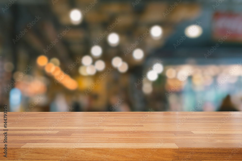 Empty wooden table and bokeh of interior background