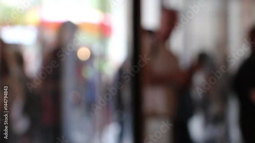 defocused people enter shop