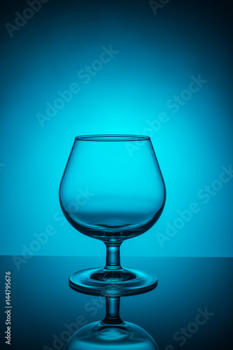 Empty wine glass on a blue background
