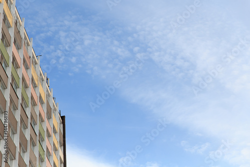 The new multi-storey residential building against blue sky.