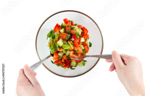 Young woman preparing healthy vegetable salad. photo