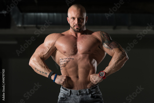 Muscular Man Flexing Back Muscles Pose