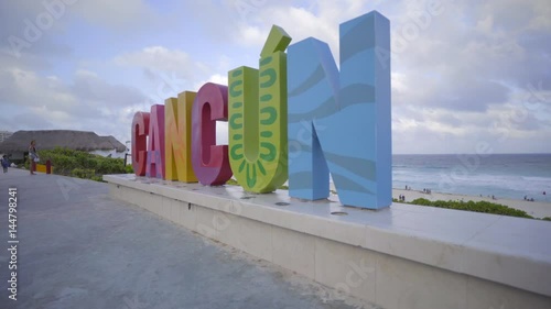 Left pan of the Cancun sign on the beach photo