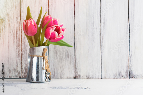 Fototapeta Naklejka Na Ścianę i Meble -  Pink tulips in metal pitcher