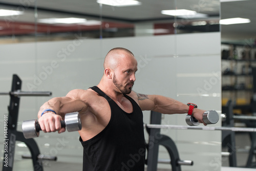 Shoulder Exercise With Dumbbell In A Gym