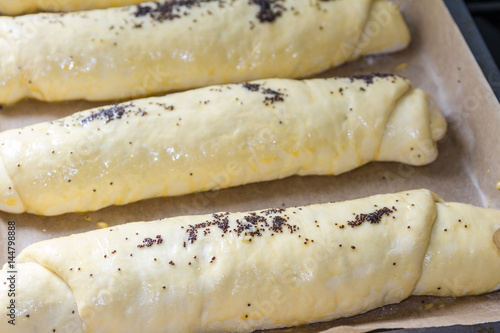 Roll with poppy seeds on a baking sheet