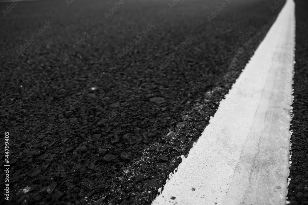 Fototapeta premium Asphalt road line white texture close up.